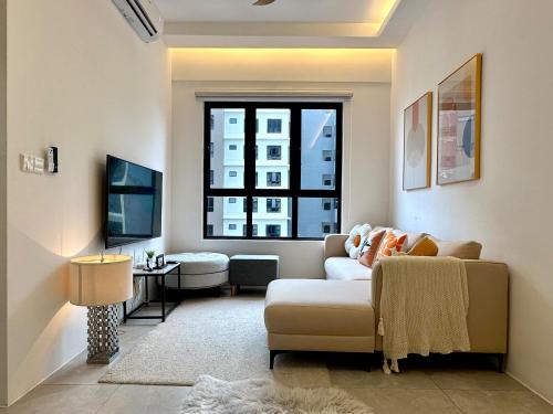 a living room with a couch and a window at Aston Acacia Residence Bukit Mertajam in Bukit Mertajam