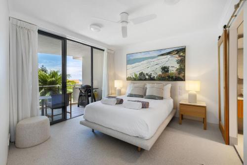 a bedroom with a large white bed and a balcony at Unit 3 21 Park Generous and Comfortable Beachside Abode in Sunshine Beach
