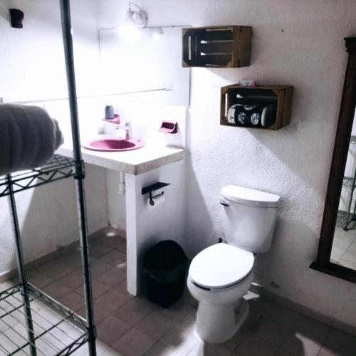 a bathroom with a toilet and a sink at Casa Ix Milagros in Huay Pix