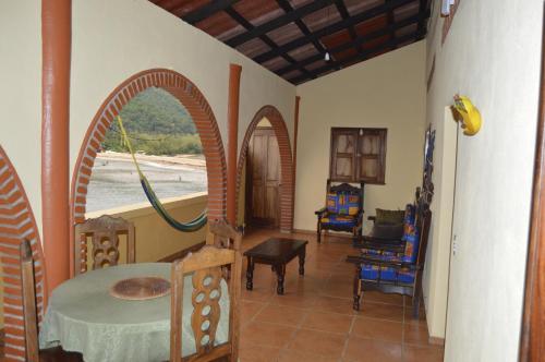 a living room with arches and a table and chairs at Casa Papaya in Yelapa