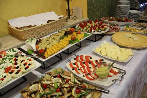 a buffet with many different types of food on a table at Sosnowe Zacisze in Białystok