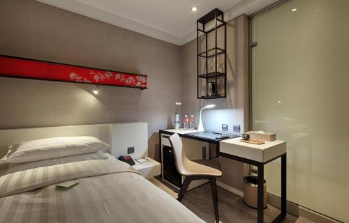 Postel nebo postele na pokoji v ubytování City Place Hotel