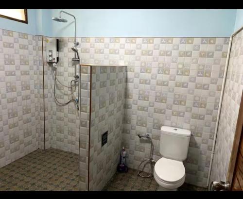 a bathroom with a shower and a toilet in it at Srisook House in Ko Phangan