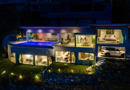 an aerial view of a house at night at Iconic 5BR Panoramic Seaview Authentic Boho Villa in Koh Samui