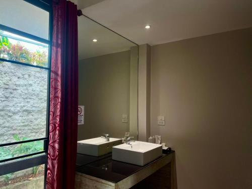 a bathroom with two sinks and a large mirror at Laan Mai Fai Chang Resort in Chiang Mai