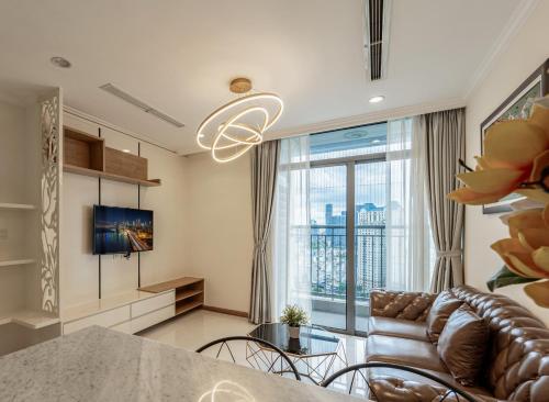 a living room with a couch and a tv at Luminous Landmark Apartment in Ho Chi Minh City