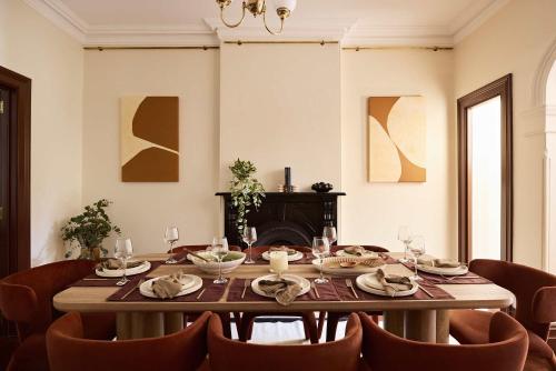 a dining room with a table and chairs at Grand 4BR Paddington Terrace - Free parking in Sydney