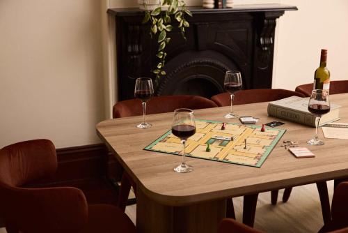 a table with three glasses of wine on it at Grand 4BR Paddington Terrace - Free parking in Sydney