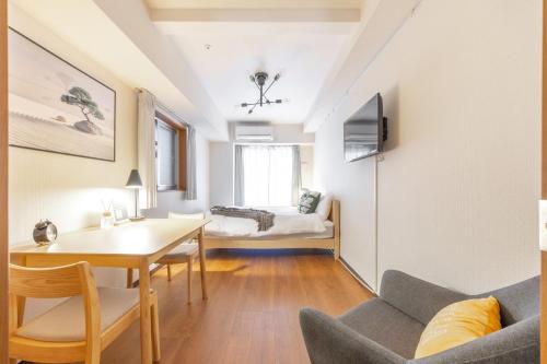 a small living room with a table and a couch at Dash Living Shinjuku in Tokyo