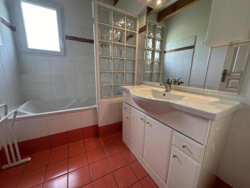 a bathroom with a sink and a bath tub at Gite de lescurade in Escource