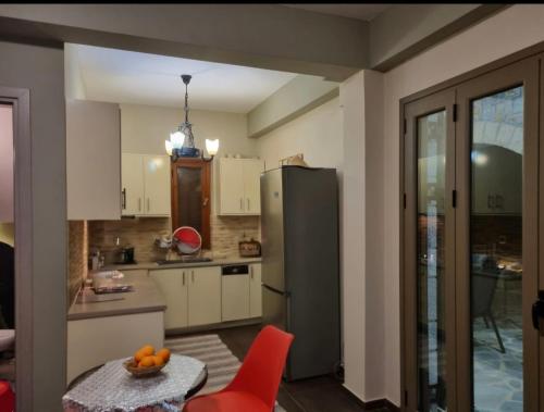 a kitchen with a refrigerator and a table at Galini Stone House in Proástion
