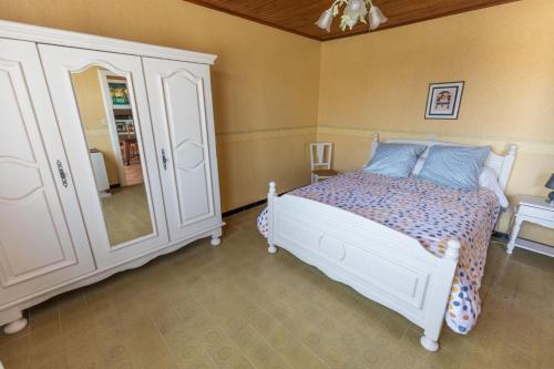 a bedroom with a bed and a dresser and a mirror at Bachale in Lamothe