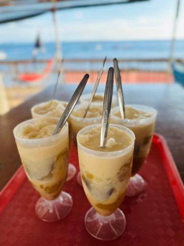 a tray with four glasses of food on a table at Kantil Dive Resort in Batangas City