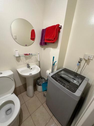 een kleine badkamer met toilet en wastafel bij Stanford Suites 1 in Silang