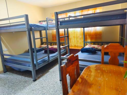 a room with three bunk beds in a room at Baguio Staycation with Mountain View in La Trinidad