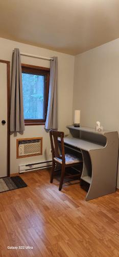 a room with a desk and a chair and a window at Brown Family Farm in Grand Forks