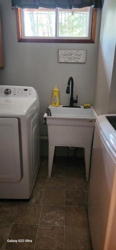 a kitchen with a sink and a washing machine at Brown Family Farm in Grand Forks