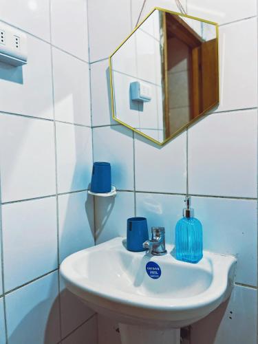 a bathroom with a sink and a mirror at Refugio araucano - Lican Ray in Licán Ray