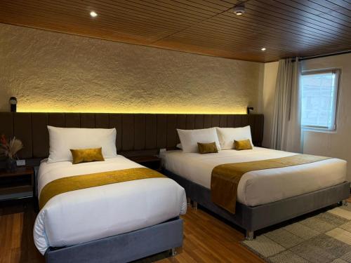 En eller flere senge i et værelse på Casa Tiyay