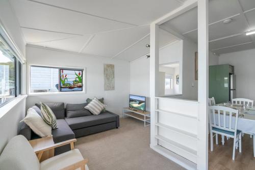 a living room with a couch and a table at The Fishin' Shack in Burrill Lake