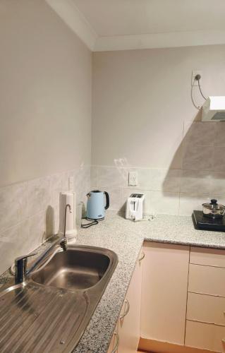 Η κουζίνα ή μικρή κουζίνα στο Bayview Holiday Flat