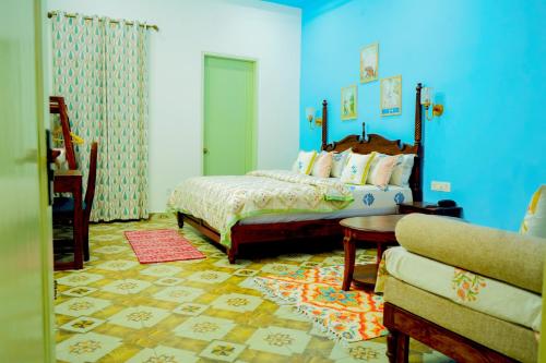 a bedroom with a bed and a couch at The Gulmohar Villa in Tājganj