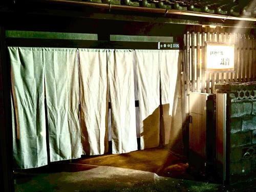 a window with white curtains in a room at 伊勢別邸風音 in Ise