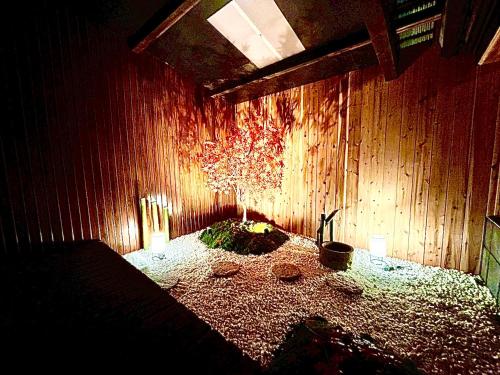 a room with a bed in a wooden wall at 伊勢別邸風音 in Ise