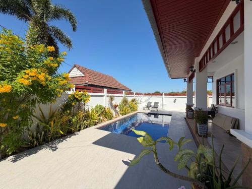 a swimming pool in the backyard of a house at Private Pool-Villa Baan Roth, Gated community 24/7 in Hua Hin