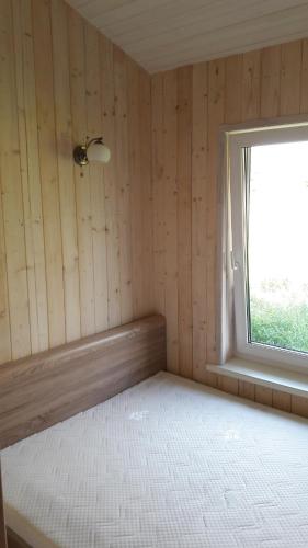 an empty room with a window and a mattress at Pape Rogas in Pape