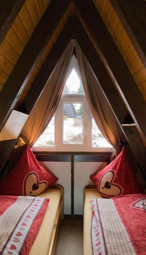two beds in a room with a window at Haus Sternenblick 22 in Freyung