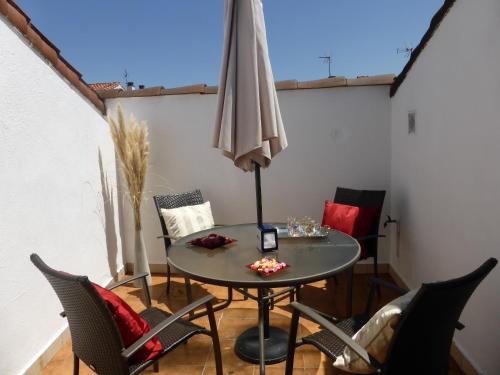 a table and chairs with an umbrella on a patio at Casa Rural Reparaz in Arbizu