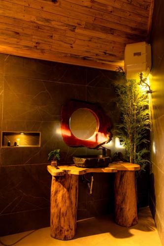 a bathroom with a table with a mirror on the wall at Kilimani Villa in Moshi
