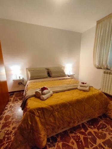 a bedroom with a large bed with towels on it at La Casa del Fungo in Montalto Uffugo