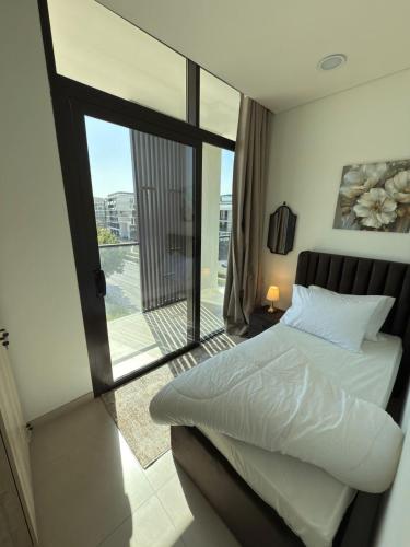 a bedroom with a bed and a large window at Nuchiii residence in Dubai