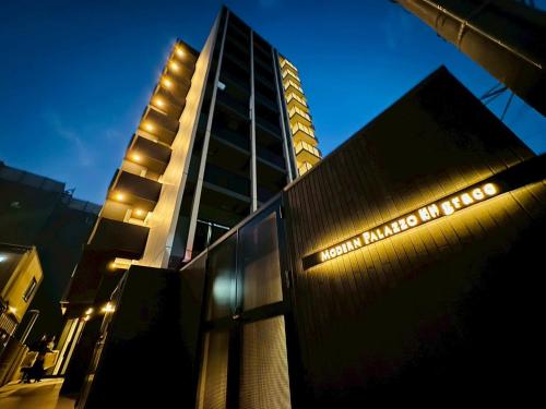 a building with a sign in front of it at LuxurySweet East71 最大7人 ペット可 箱崎宮前駅徒歩3分 新築 in Fukuoka