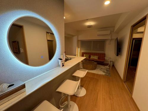 a bathroom with a sink and a mirror on the wall at LuxurySweet East71 最大7人 ペット可 箱崎宮前駅徒歩3分 新築 in Fukuoka