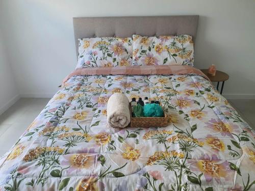 a bed with a stuffed animal in a basket on it at Quiet Spacious Room in a Shared Family Home in Yarrabilba