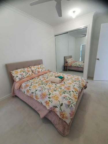 a bedroom with a large bed and a mirror at Quiet Spacious Room in a Shared Family Home in Yarrabilba in Plunkett Station