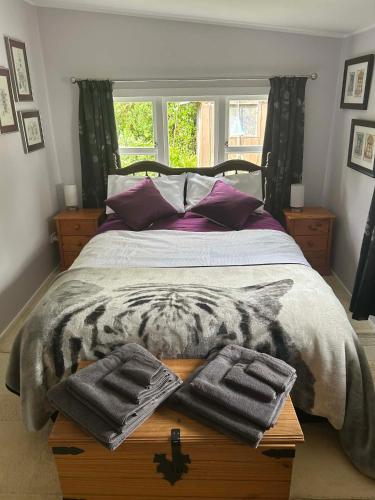 a bed with two towels on a wooden table at Beachy Sounds House in Carters Beach
