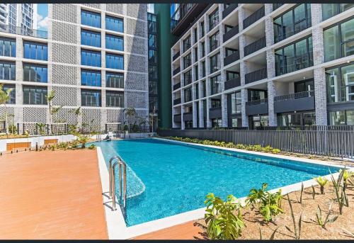 a swimming pool in front of a building at SOP06 Stylish and Cosy 2 Bedroom Apt in Sydney