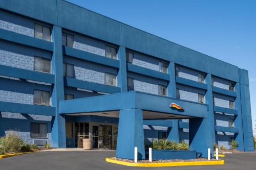 a blue building with a kite in front of it at Days Inn by Wyndham Davenport in Davenport