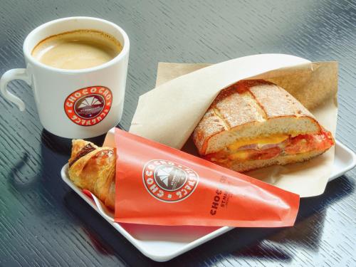 a sandwich and a cup of coffee on a table at Nishitetsu Inn Shinjuku in Tokyo