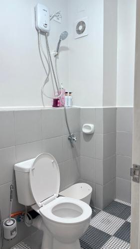 a bathroom with a toilet and a shower at 2BR Condo Near IT Park and Malls in Mandaue City