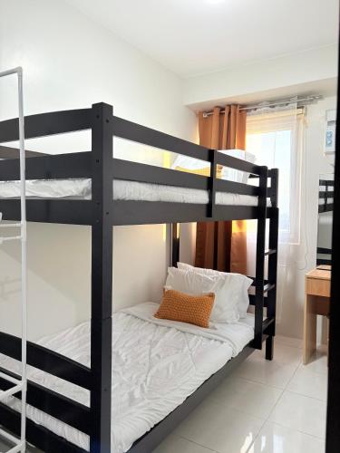 a couple of bunk beds in a room at 2BR Condo Near IT Park and Malls in Mandaue City