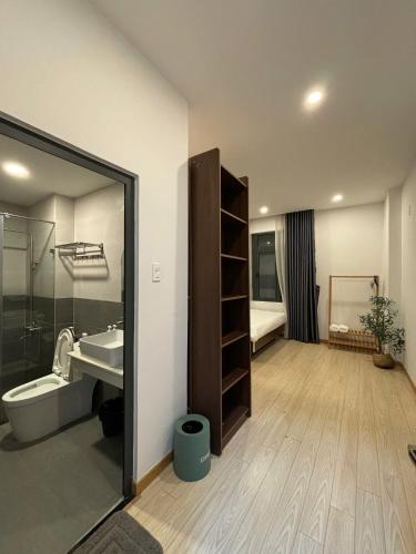 a bathroom with a sink and a toilet and a shower at Quỳnh An Home in Da Lat