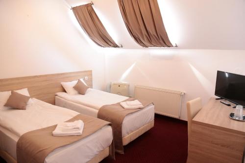 TV a/nebo společenská místnost v ubytování Hotel Apollonia