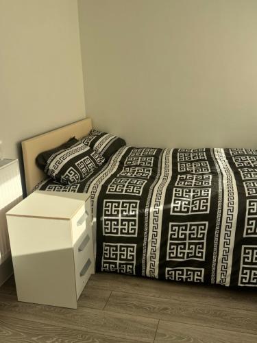 a bedroom with a bed and two pillows at Systematic Home in Battlesbridge