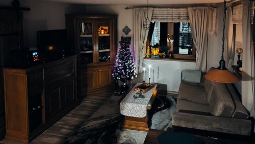 a living room with a christmas tree and a couch at Na Divokom Vŕšku in Jamník