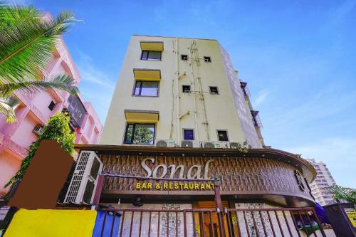 a building with a seafood bar and restaurant sign on it at Hotel O Shalimar in Mumbai